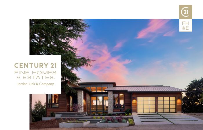 Modern luxury home with a contemporary design, large windows, and a beautifully landscaped front yard at sunset, labeled "CENTURY 21 Fine Homes & Estates, Jordan-Link & Company."